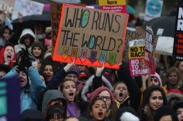Protesters hold up placards during the Women's March in London on Jan. 21, 2018