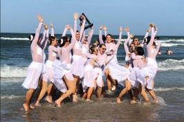 UNH Dance Team celebrating by the ocean
