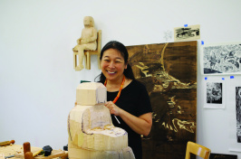 Sachiko Akiyama works on a large wood sculpture