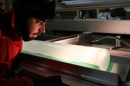 Joe Souney inspects an ice core from Antarctica.