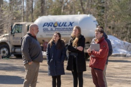 Proulx Oil representative talking with Paul College students in front of Proulx truck