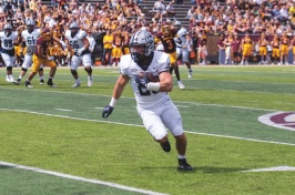 Dylan Laube runs with the ball