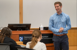 Steve Irlbeck in front of a Paul College speaking with students.