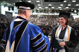 Student shakes president's hand while receiving diploma