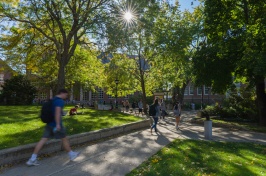 students walking along path outside of academic building