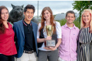 pscyhology students with psych cup in front of cat sculpture