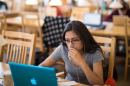 UNH student at her computer in Dimond Library 