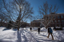 UNH students walking through a snowy campus