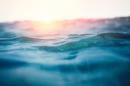 close up of ocean waves with the sun setting