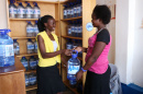 A woman purchases water from a Jibu franchisee.