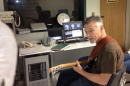 Professor Don Robin playing the guitar while subject undergoes brain scan.