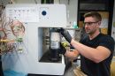 UNH student Christopher Bales '18 conducting chemical engineering research