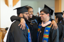 UNH graduates celebrating during pre-commencement reception in library