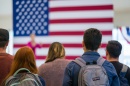 students in front of American flag