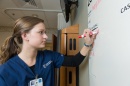 nursing student working on white board