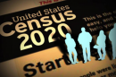 A picture of the words "Census 2020" with cut out men and women standing to the right of it. 