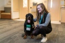 Alexandra Tomwey with a service dog