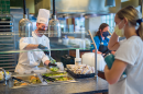 student being served in one of UNH's dining halls