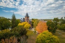 Aerial photo of UNH campus in fall, with bright trees in front of T Hall