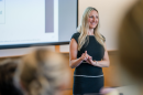 Kelly Root lectures in front of a classroom at Paul College.