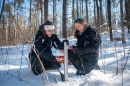 Two female researchers working in a snowy field