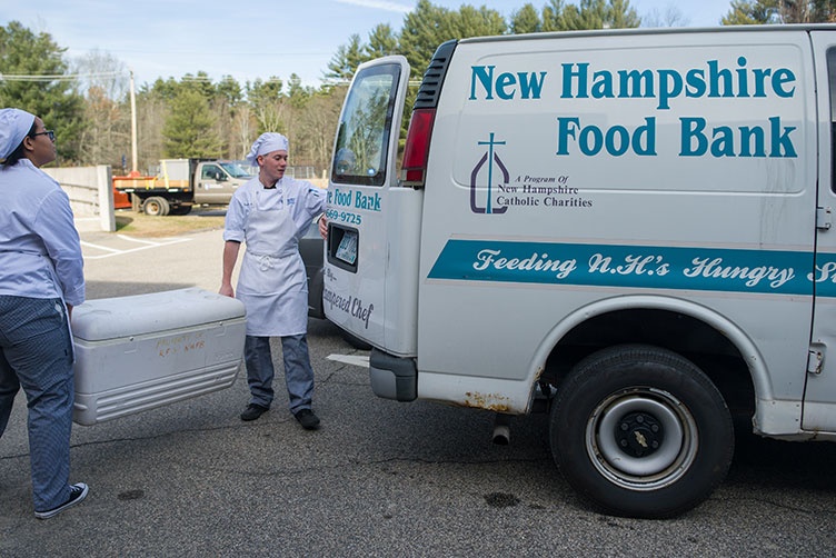 Brad LaMonica and Ciara McCarter from UNH’s Thompson School of Applied Science Culinary Arts & Nutrition program load tilapia onto N.H. Food Bank truck