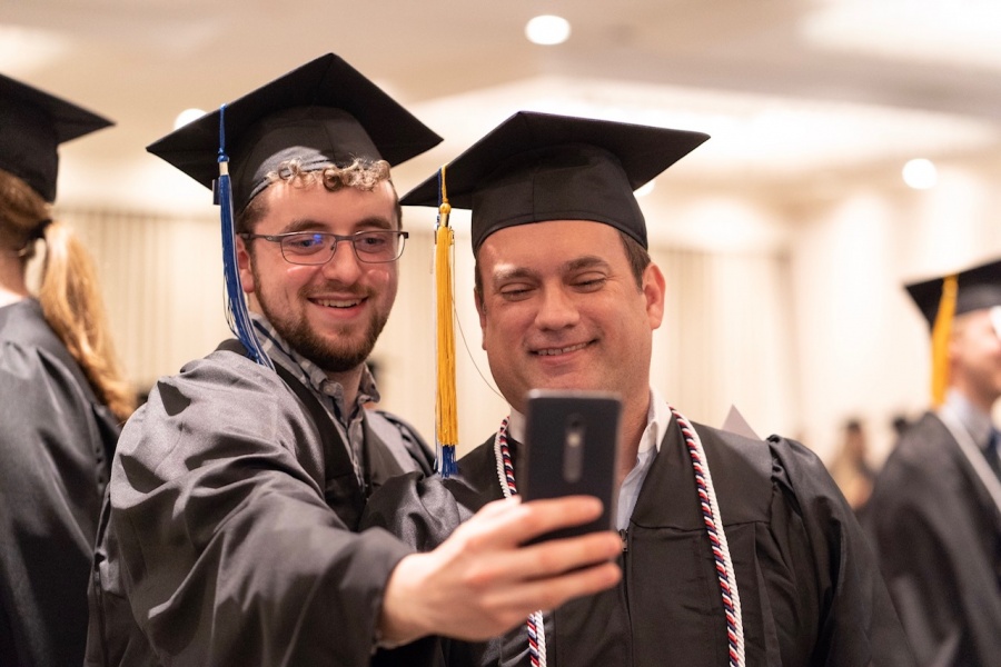 UNH Manchester graduates pose for a selfie