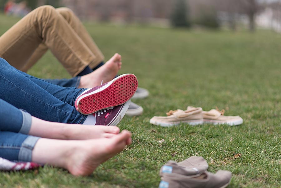 Bare feet on Thompson Hall lawn at UNH