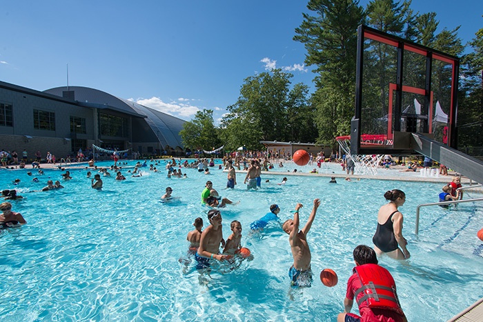 kids playing water basketball at the opening of UNH's new outdoor pool