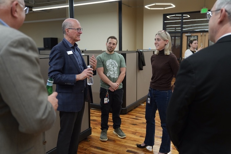 President Dean speaks with two alums at BioFabUSA