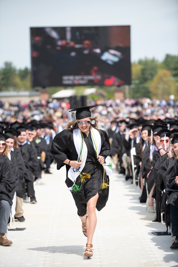 UNH Graduate Elinor Purrier '18 running towards the stage at UNH commencement 2018