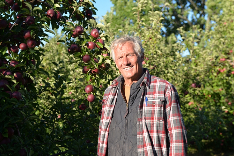 Peter Wagner stands in his apple orchard. 