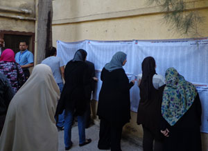 Egyptians in a polling center reviewing results.